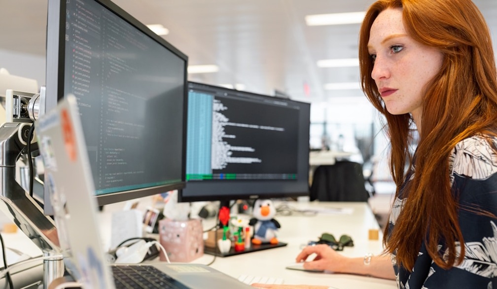 A woman in an office researching buying intent on her computer