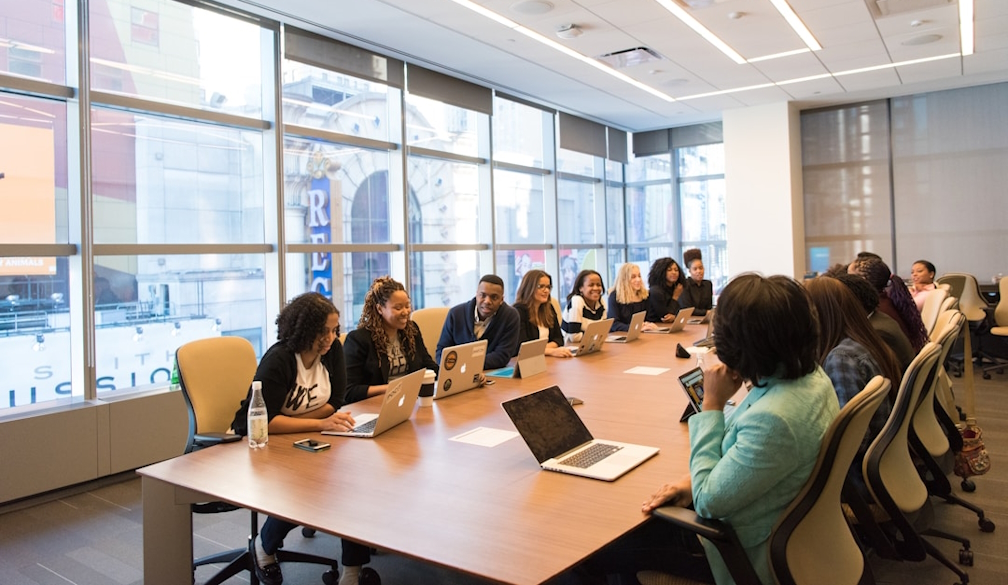 A team in an office discussing buying intent during a meeting