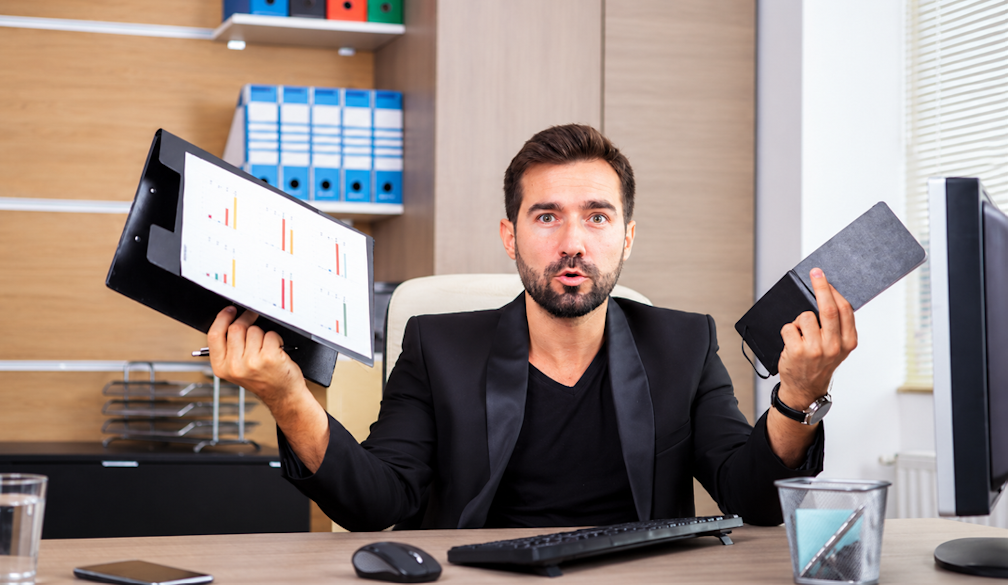 Perplexed Executive Comparing Office Files
