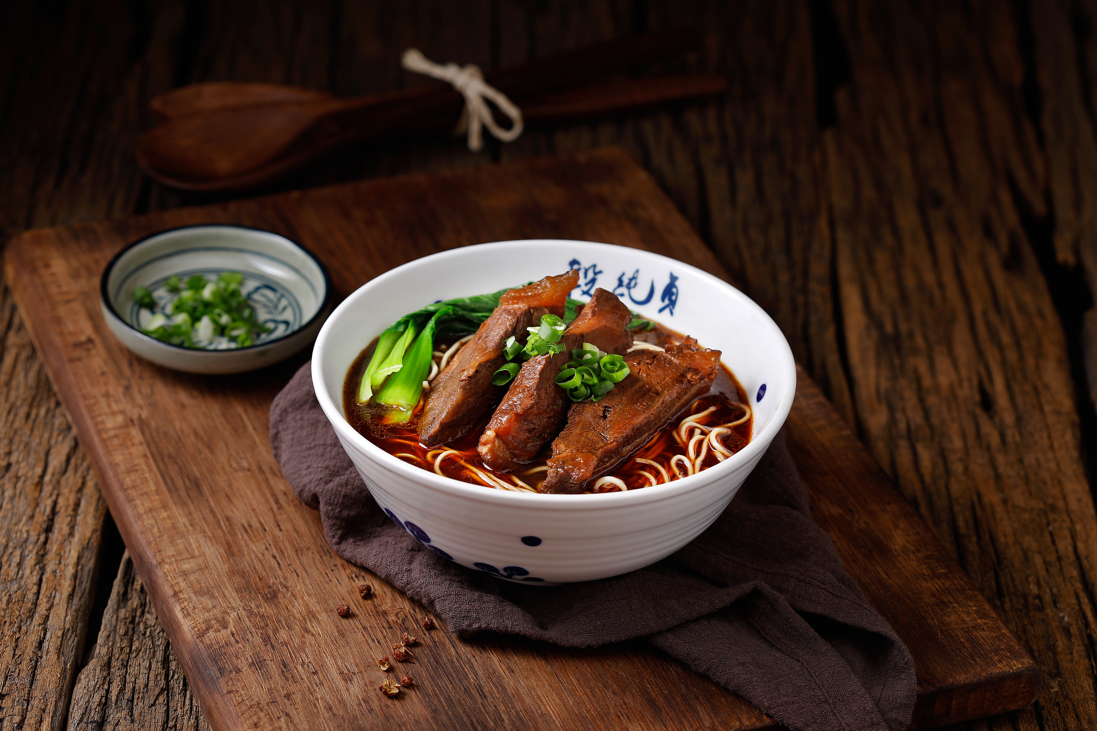 Duan Chun Zhen’s signature Braised Beef Noodle Soup, featuring a rich broth simmered with over 23 herbs and spices.