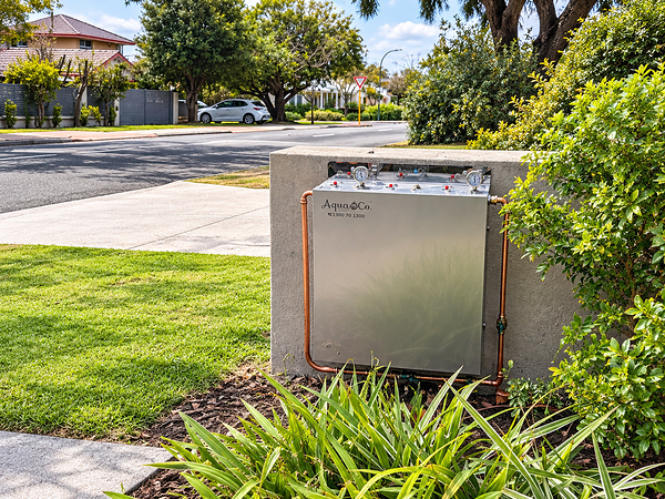 An AquaCo water filtration system installed at the front of an Australian home for complete home filtration. An AquaCo water filtration system installed at the front of an Australian home for complete home filtration.